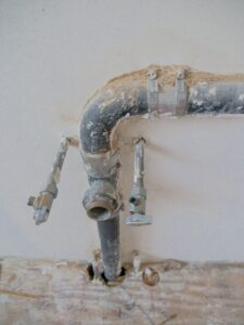 Clogged drain vs. main line vs. septic — exposed household plumbing pipes