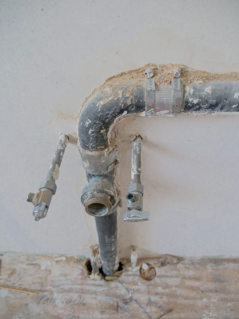 Clogged drain vs. main line vs. septic — exposed household plumbing pipes